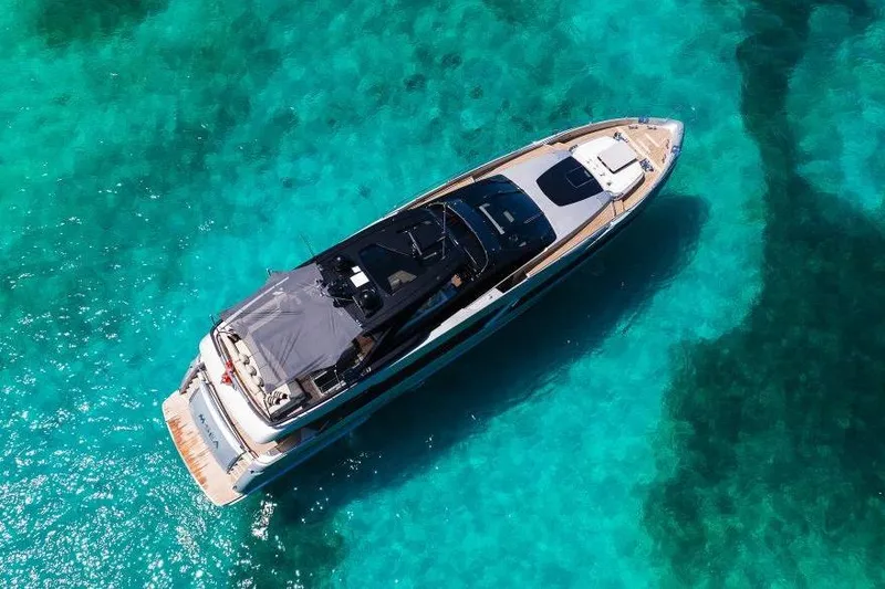 Slide: The Image of Aerial view of 2022 Riva 90' Argo yacht on clear turquoise water. - 54