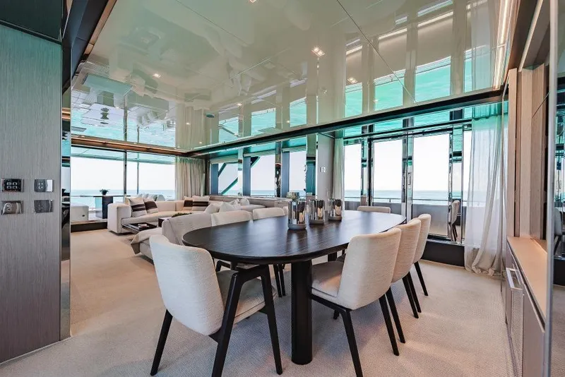 Slide: The Image of Luxurious interior of 2022 Riva 90' Argo yacht with elegant dining area and panoramic windows. - 15