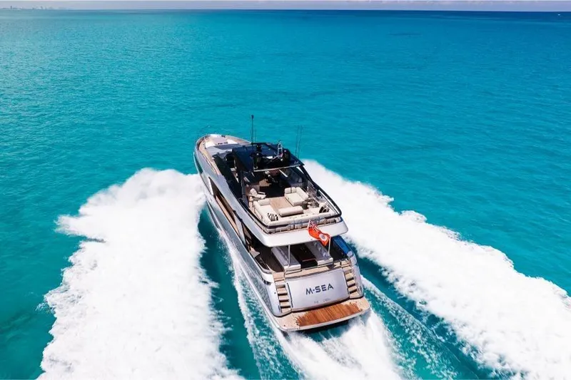 Slide: The Image of Luxurious 2022 Riva 90' Argo yacht cruising on vibrant turquoise waters. - 7