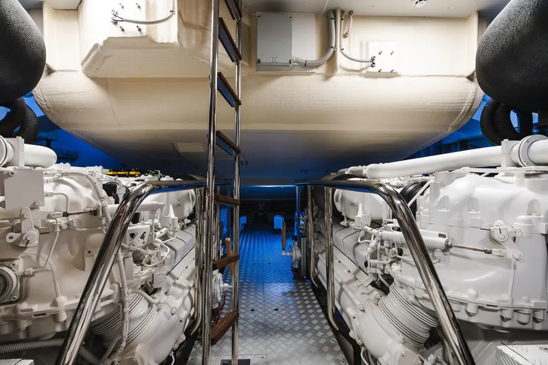 Slide: The Image of Engine room of 2022 Riva 90' Argo yacht, featuring dual engines and metallic flooring. - 51