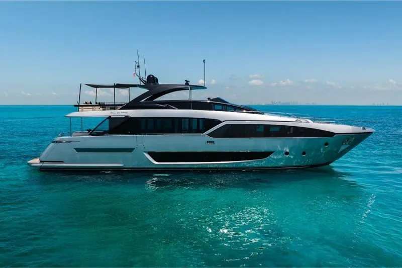 Slide: The Image of Luxury 2022 Riva 90' Argo yacht on clear blue ocean waters. - 2