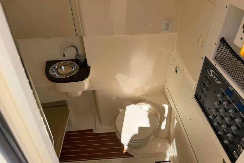 Slide: The Image of 2019 Scout 300 LXF boat interior with sink, toilet, and control panel. - 11