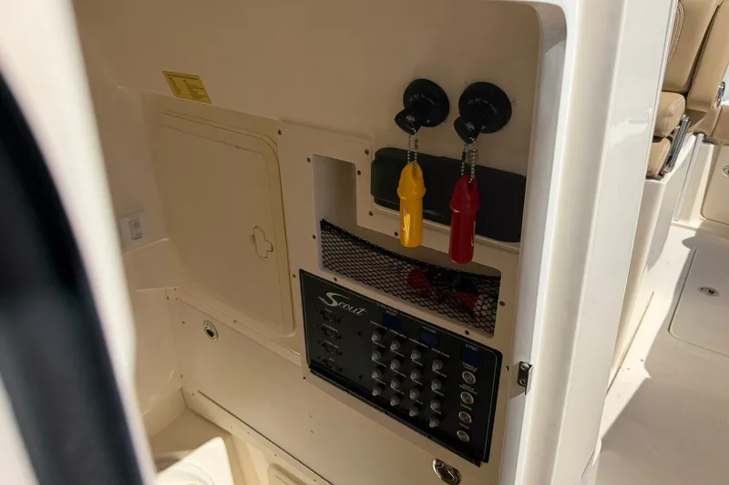 Slide: The Image of Control panel of a 2019 Scout 300 LXF boat with switches and keychains. - 12