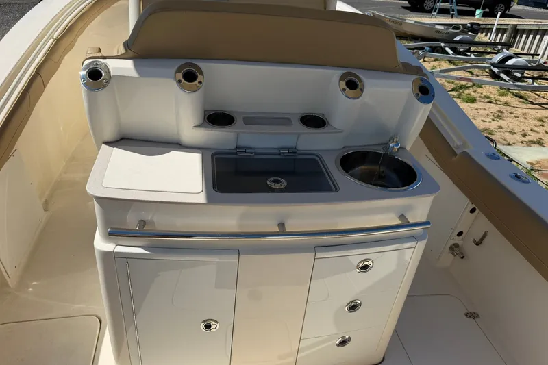 Slide: The Image of 2019 Scout 300 LXF boat interior with sink and storage area. - 16