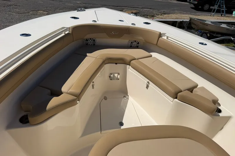 Slide: The Image of 2019 Scout 300 LXF boat interior with tan seating and storage compartments. - 23