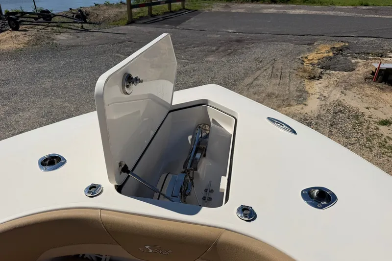 Slide: The Image of 2019 Scout 300 LXF boat anchor compartment open on deck. - 25