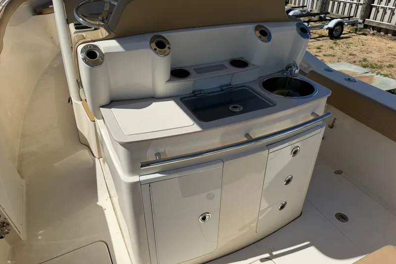 Slide: The Image of 2019 Scout 300 LXF boat interior with sink and storage compartments. - 15