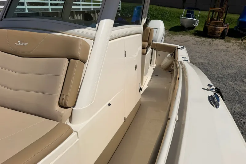 Slide: The Image of 2019 Scout 300 LXF boat interior with tan seating and sleek design. - 9