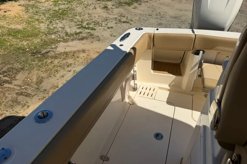 Slide: The Image of 2019 Scout 300 LXF boat interior with beige seating and deck details. - 21