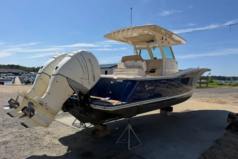 Slide: The Image of 2019 Scout 300 LXF boat with dual Mercury engines on a sunny day. - 4