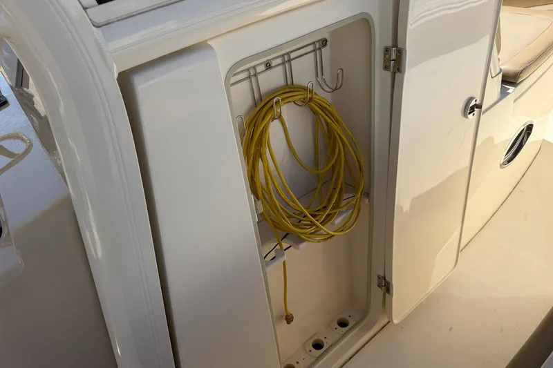 Slide: The Image of Storage compartment with yellow rope on a 2019 Scout 300 LXF boat. - 20