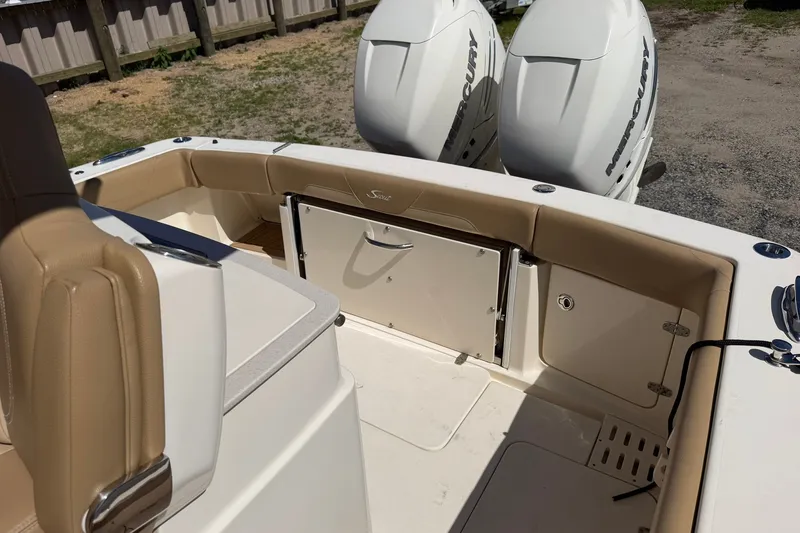 Slide: The Image of 2019 Scout 300 LXF boat interior with twin Mercury engines and tan seating. - 13