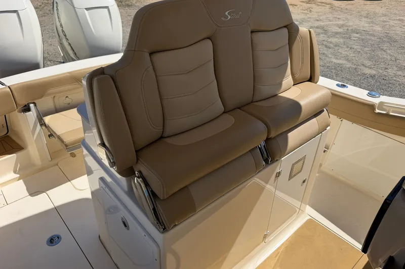 Slide: The Image of 2019 Scout 300 LXF boat with tan leather seating and dual outboard motors. - 17
