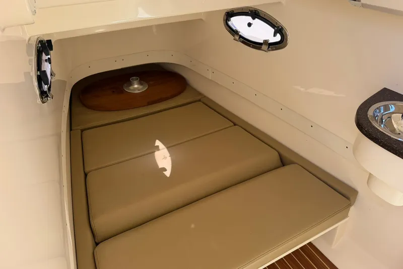 Slide: The Image of 2019 Scout 300 LXF cabin interior with beige cushions and portholes. - 10