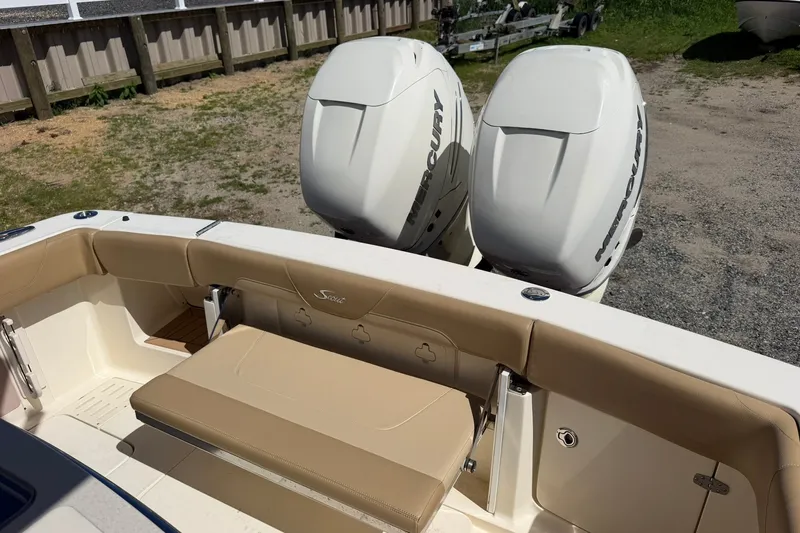 Slide: The Image of 2019 Scout 300 LXF boat with dual Mercury engines and tan seating. - 14