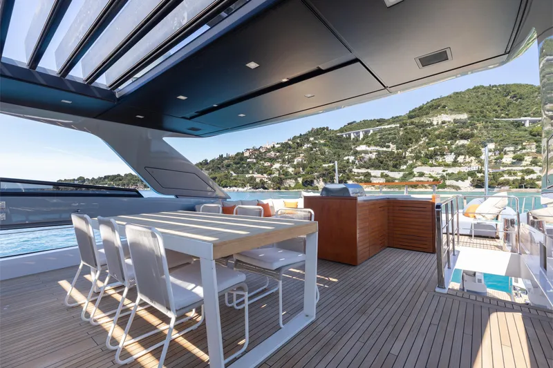 Slide: The Image of Luxurious 2022 Sanlorenzo SL106A yacht deck with dining area and scenic ocean view. - 31