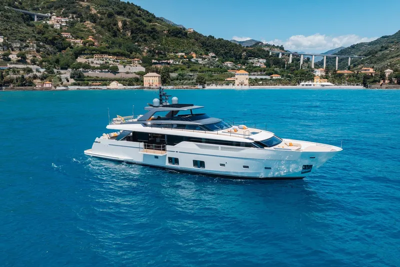 Slide: The Image of Luxurious 2022 Sanlorenzo SL106A yacht cruising in vibrant blue waters near scenic coastline. - 43