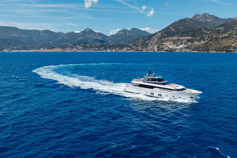 Slide: The Image of Luxurious 2022 Sanlorenzo SL106A yacht cruising in blue ocean with scenic mountain backdrop. - 47