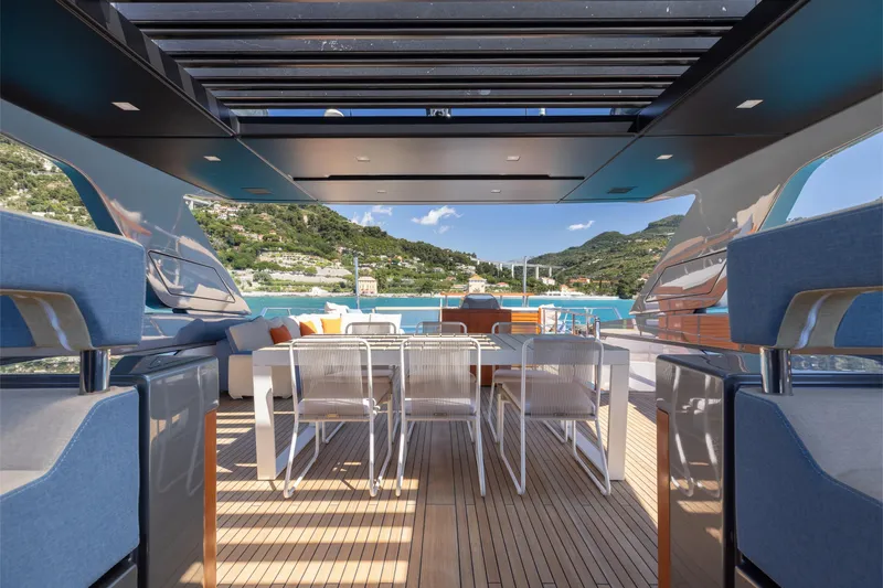 Slide: The Image of Luxurious 2022 Sanlorenzo SL106A yacht deck with elegant seating and scenic coastal view. - 32