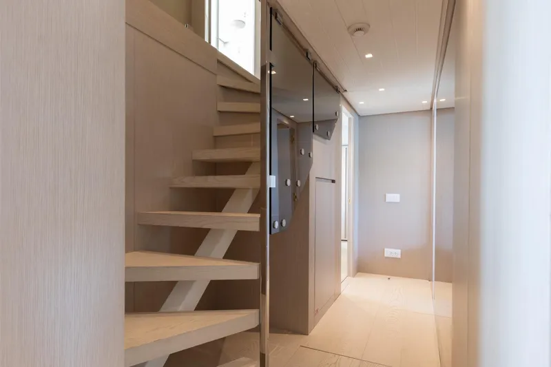 Slide: The Image of Modern interior of 2022 Sanlorenzo SL106A yacht featuring sleek wooden staircase design. - 25