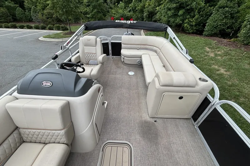 Slide: The Image of 2023 Ranger 223C pontoon boat with spacious seating and modern interior design. - 20