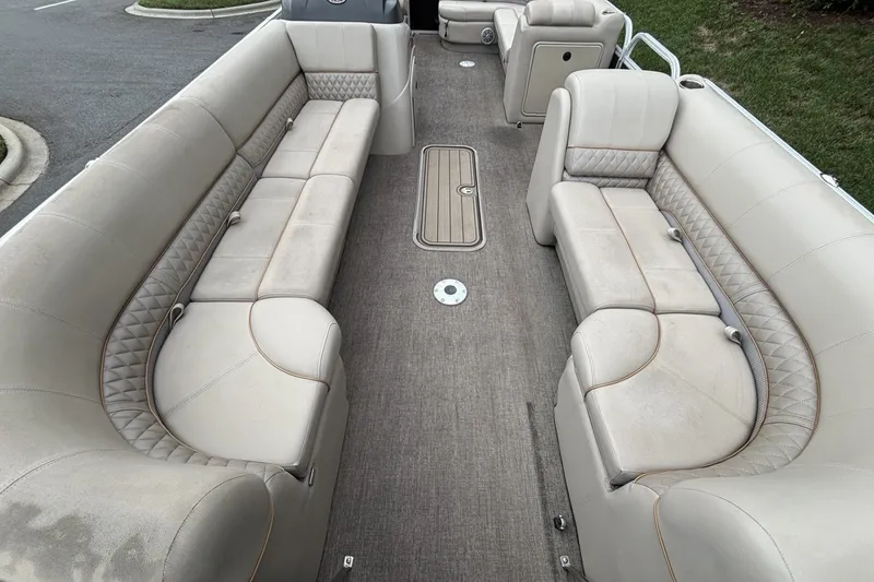 Slide: The Image of 2023 Ranger 223C boat interior with beige seating and carpeted floor. - 18
