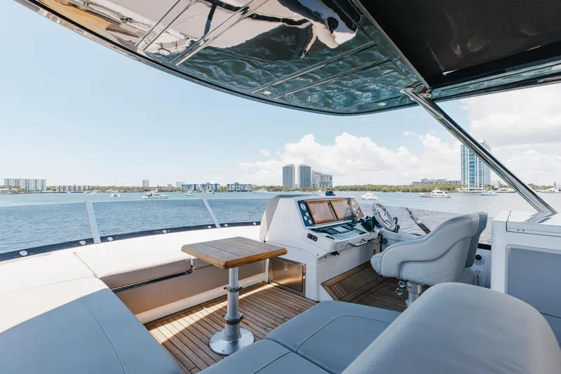 Slide: The Image of Luxurious 2022 Sunseeker 76 Yacht helm with panoramic waterfront view. - 84