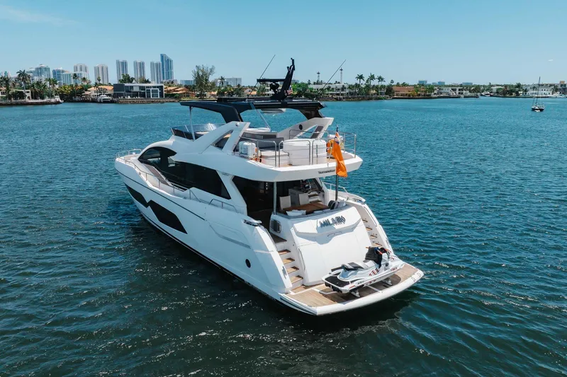 Slide: The Image of Luxurious 2022 Sunseeker 76 Yacht cruising on a sunny day near a city skyline. - 18