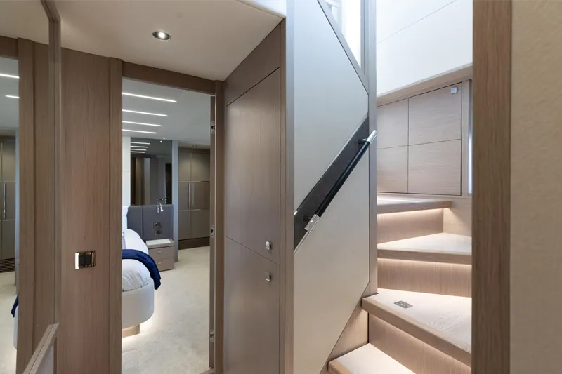 Slide: The Image of Luxurious interior of 2022 Sunseeker 76 Yacht, featuring elegant staircase and modern bedroom. - 51