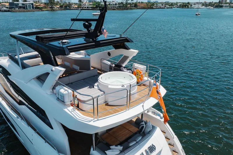 Slide: The Image of Luxurious 2022 Sunseeker 76 Yacht with jacuzzi on open deck, cruising on serene waters. - 17