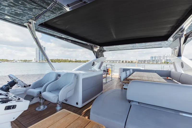 Slide: The Image of Luxurious 2022 Sunseeker 76 Yacht interior with modern seating and scenic waterfront view. - 83