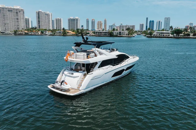 Slide: The Image of 2022 Sunseeker 76 Yacht cruising near city skyline on a sunny day. - 15