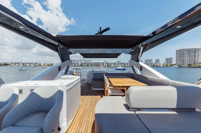 Slide: The Image of Luxurious 2022 Sunseeker 76 Yacht with spacious deck and modern seating, overlooking waterfront skyline. - 80