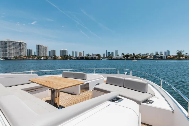 Slide: The Image of Luxurious Sunseeker 76 Yacht 2022 with spacious deck, overlooking waterfront cityscape. - 86