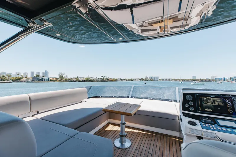 Slide: The Image of Luxurious 2022 Sunseeker 76 Yacht interior with scenic waterfront view and modern navigation system. - 81