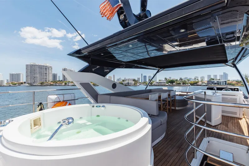 Slide: The Image of Luxurious 2022 Sunseeker 76 Yacht with jacuzzi and city skyline view. - 69
