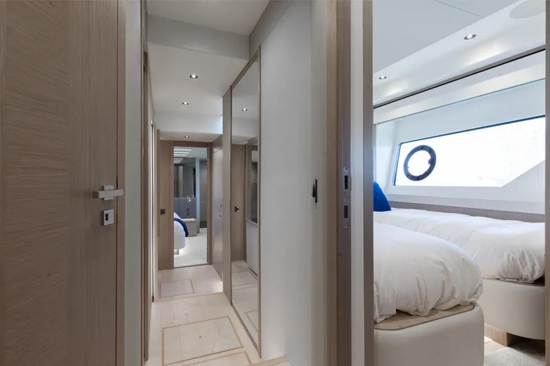 Slide: The Image of Luxurious interior of 2022 Sunseeker 76 Yacht, featuring elegant hallway and bedroom. - 60