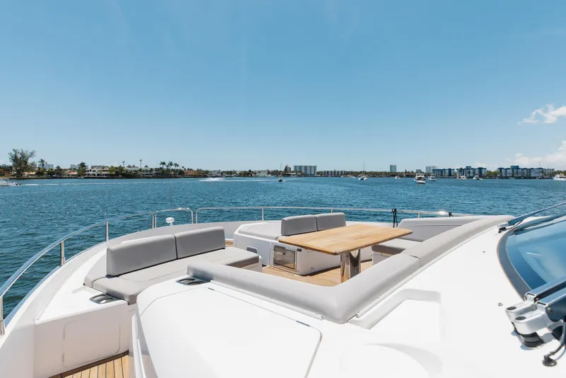 Slide: The Image of Luxurious 2022 Sunseeker 76 Yacht with spacious deck seating and scenic waterfront view. - 85
