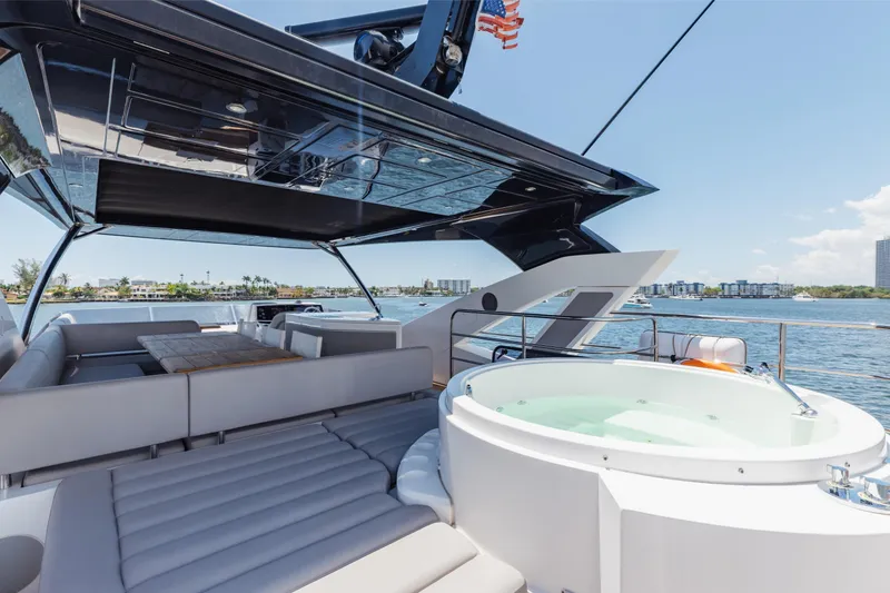 Slide: The Image of Luxurious 2022 Sunseeker 76 Yacht with jacuzzi and spacious seating area on deck. - 70