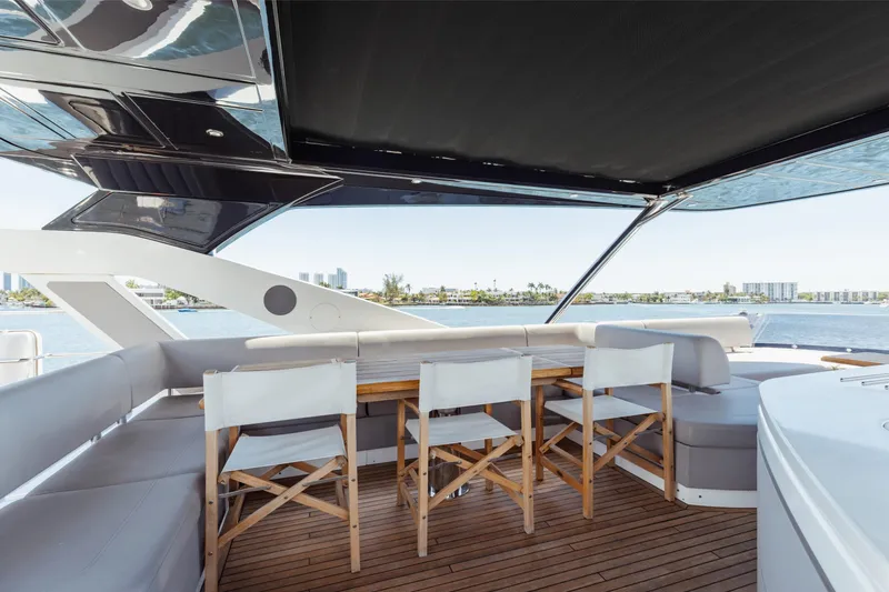 Slide: The Image of Luxurious Sunseeker 76 Yacht 2022 with elegant outdoor seating and scenic ocean view. - 77