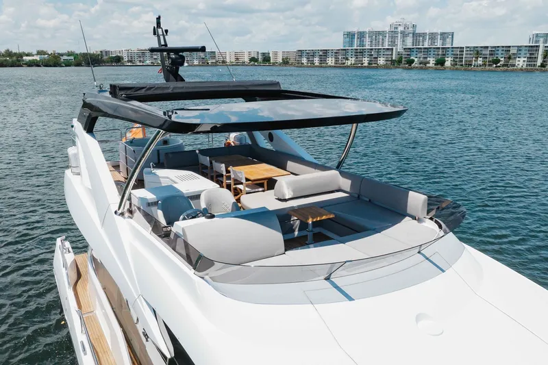 Slide: The Image of Luxurious 2022 Sunseeker 76 Yacht on serene water, featuring spacious deck and modern design. - 14