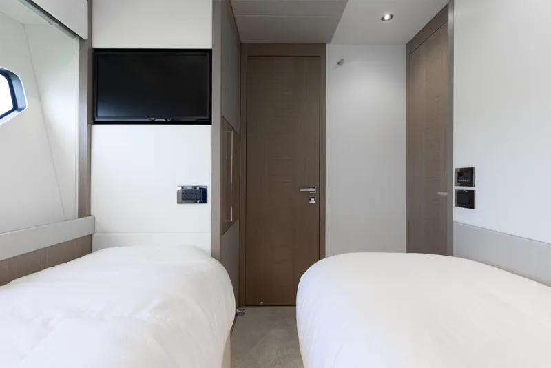 Slide: The Image of Luxurious twin bedroom in 2022 Sunseeker 76 Yacht with modern decor and TV. - 62