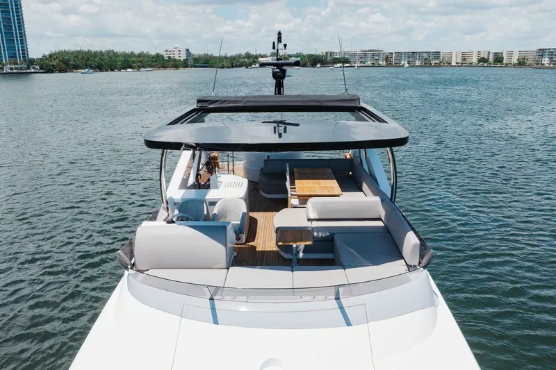 Slide: The Image of 2022 Sunseeker 76 Yacht on serene water, featuring spacious deck and modern design. - 13