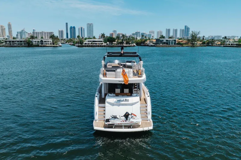 Slide: The Image of Sunseeker 76 Yacht 2022 on water with city skyline in background. - 16