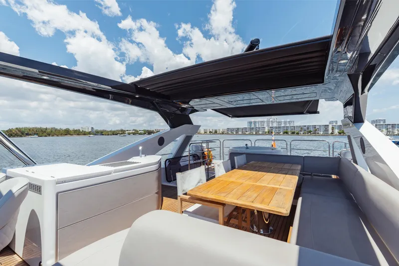 Slide: The Image of Luxurious Sunseeker 76 Yacht 2022 with spacious deck and seating area, under clear skies. - 82