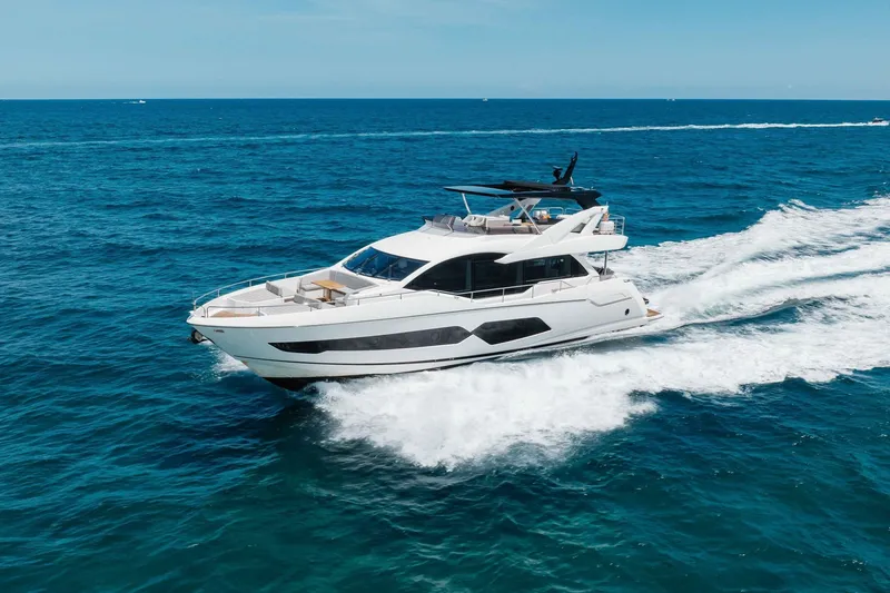 Slide: The Image of Luxurious 2022 Sunseeker 76 Yacht cruising on open blue ocean waters. - 24