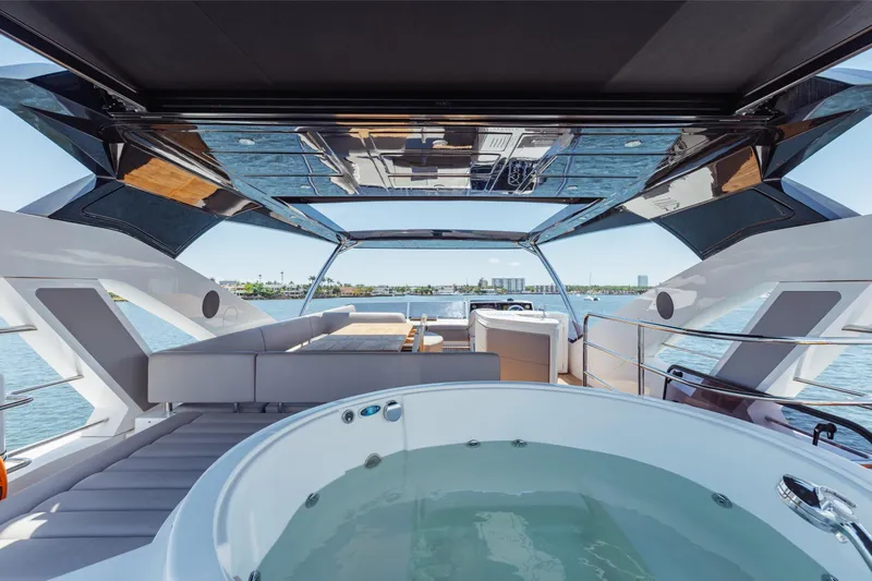 Slide: The Image of Luxurious 2022 Sunseeker 76 Yacht with jacuzzi and spacious deck overlooking the ocean. - 72