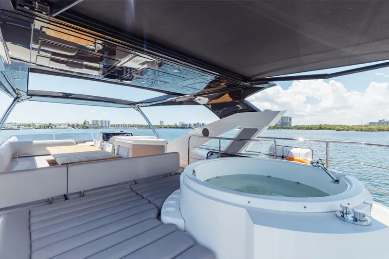 Slide: The Image of Luxurious Sunseeker 76 Yacht 2022 with jacuzzi and seating area on deck. - 73