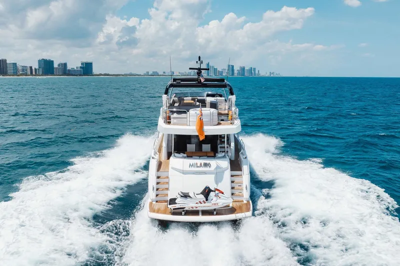 Slide: The Image of Luxury Sunseeker 76 Yacht cruising on open sea, 2022 model, city skyline in background. - 27