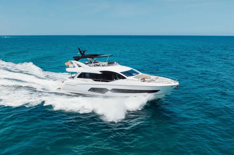 Slide: The Image of 2022 Sunseeker 76 Yacht cruising on open blue sea. - 19